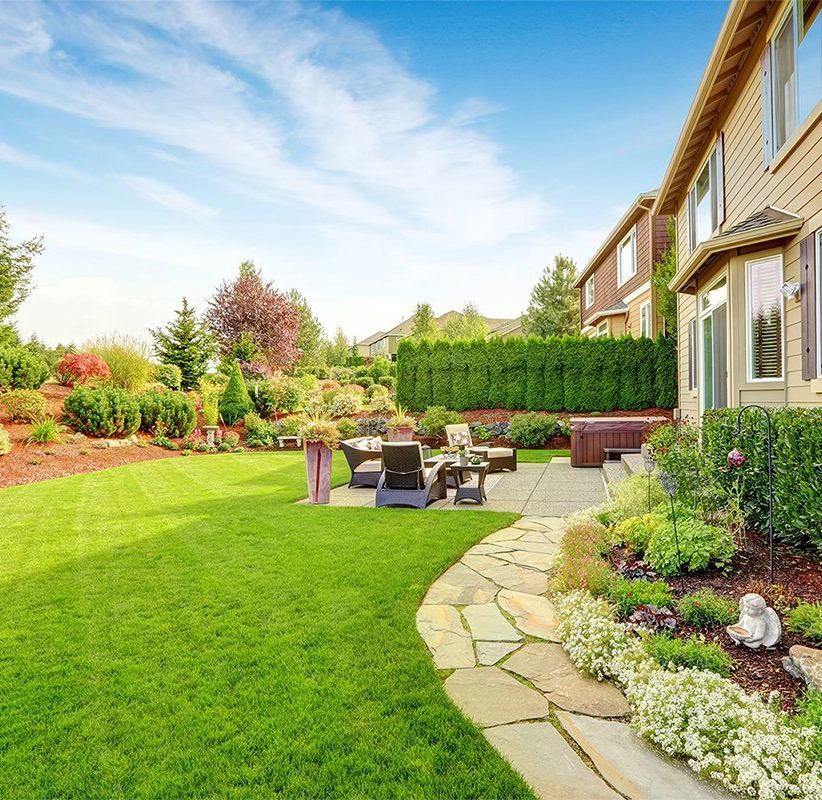 Landscaped backyard with patio, view from side of yard.