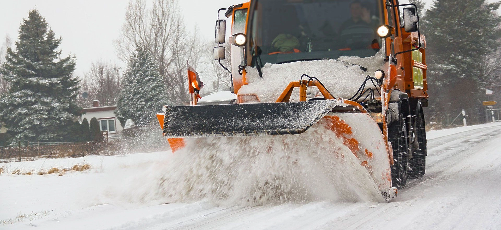 Snow plow removing snow