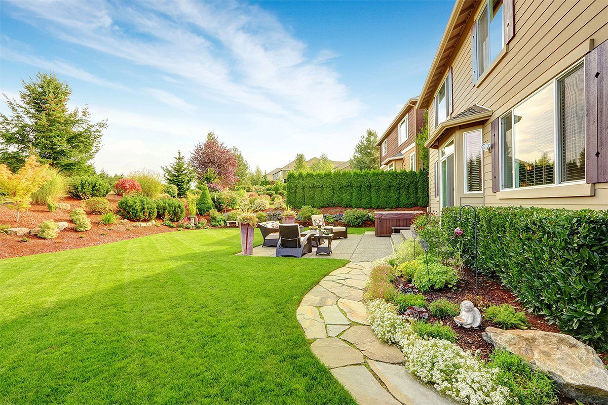 Side view of landscaped home back yard